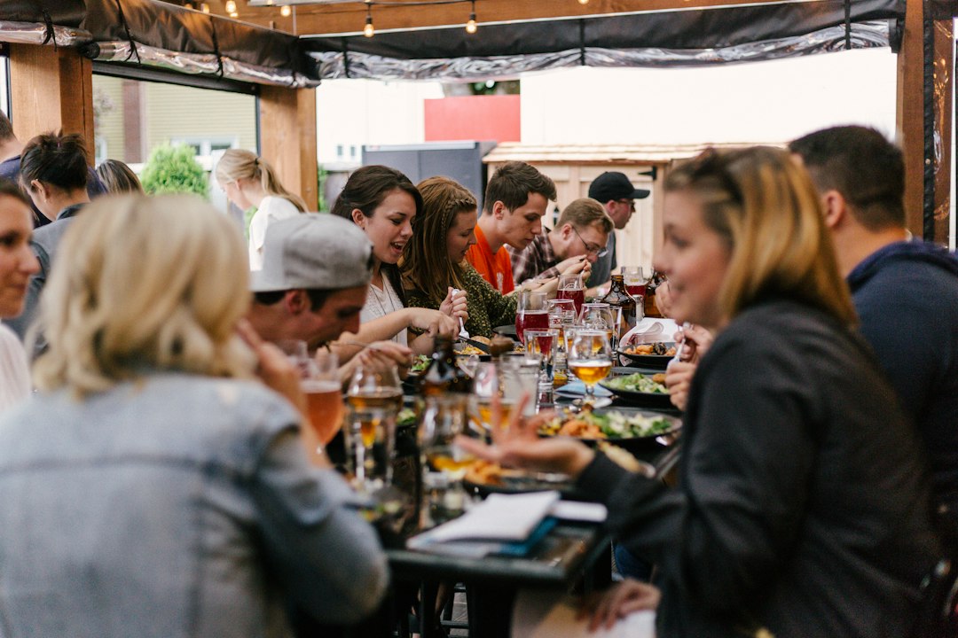 Friends seated around a table enjoying a daytime gathering
