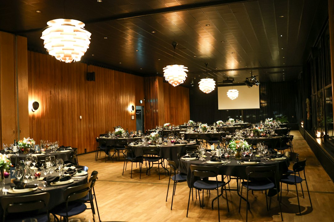 An elegant event space prepared with round tables
